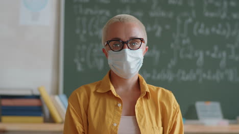 Portrait-of-Female-Teacher-in-Protective-Mask-in-Classroom
